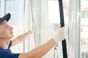 A professional replacing a double glazed glass unit as part of a window repair service